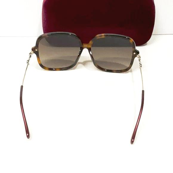Woman’s Gucci sunglasses gg0884sa brown lenses gold square frame